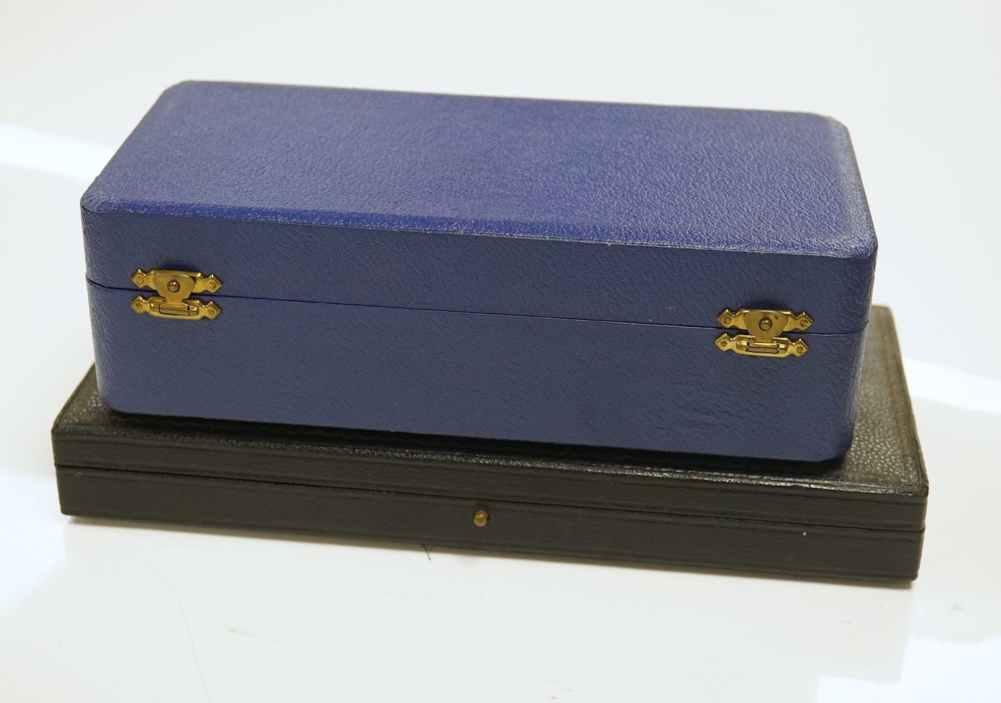 A cased 1960's three piece silver condiment set by William Suckling Ltd and and a cased pair of George III silver berry spoons, George Smith IV, London, 1812. Condition - fair
